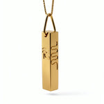 Gold geometric Egyptian necklace with a cuboid pendant featuring raised hieroglyphic symbols including a serpent from KIRO UK’s statement jewellery collection