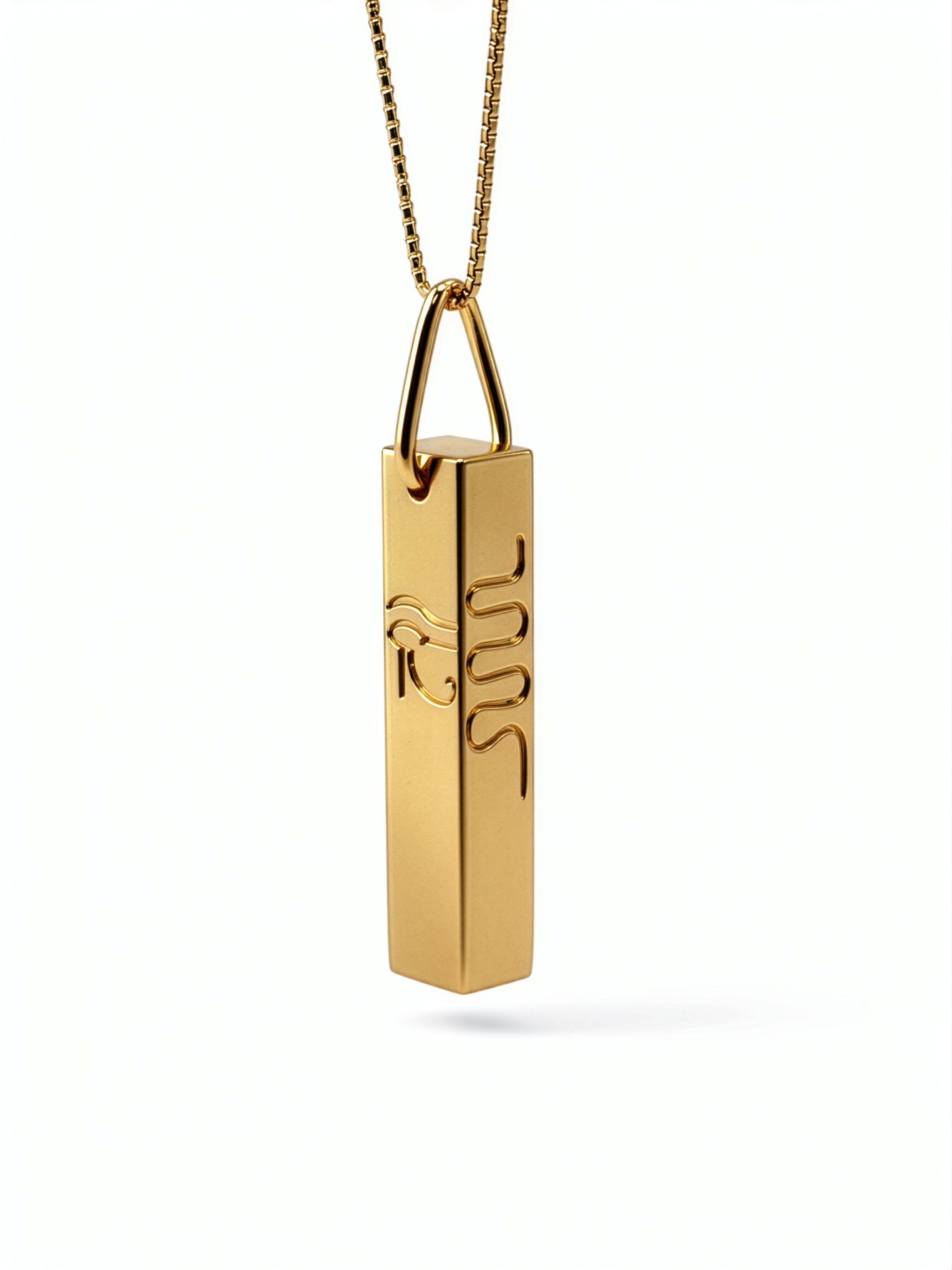 Gold geometric Egyptian necklace with a cuboid pendant featuring raised hieroglyphic symbols including a serpent from KIRO UK’s statement jewellery collection